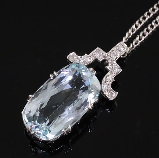 A mid 20th century white gold? mounted oval cut aquamarine pendant with diamond set bale, pendant 37mm.